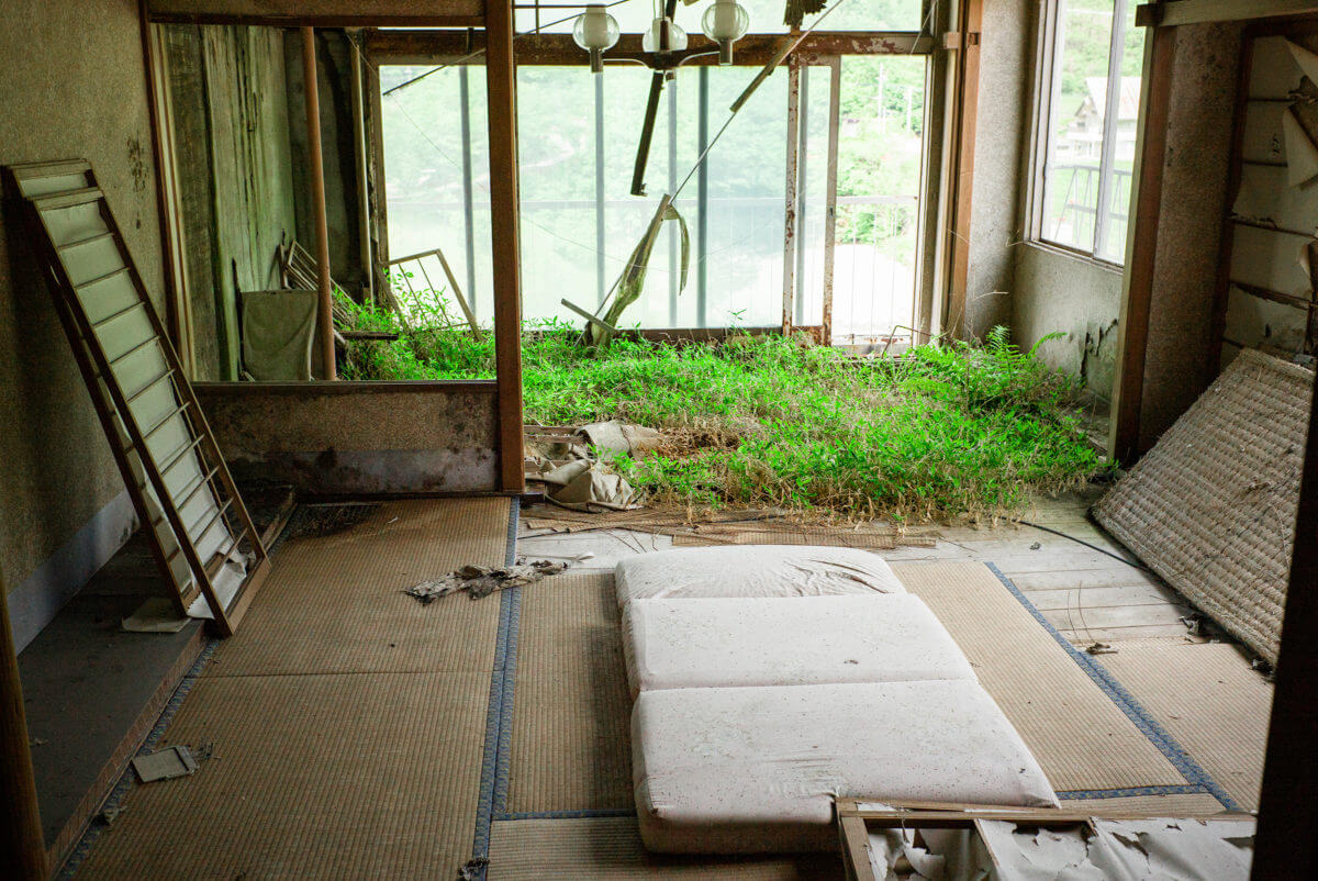 abandoned and overgrown japanese hotel
