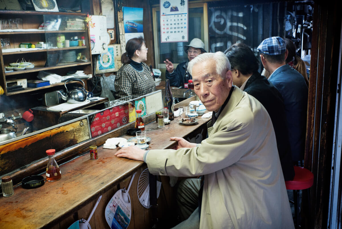 an old japanese drinker in an old bar
