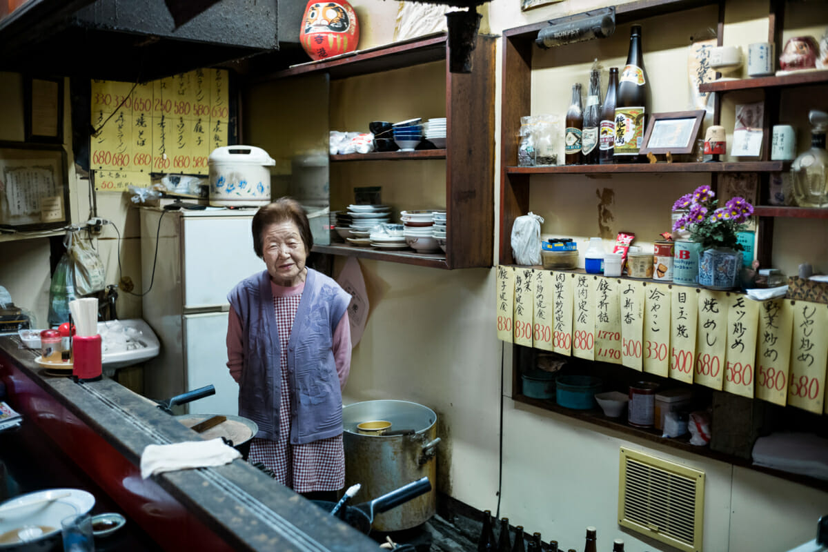 An elderly Japanese lady in her old ramen shop