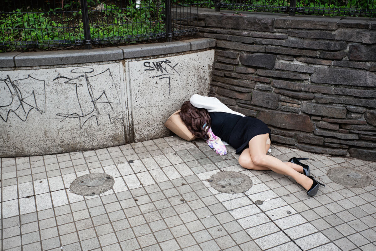 A Japanese transvestite drunk and asleep in Tokyo