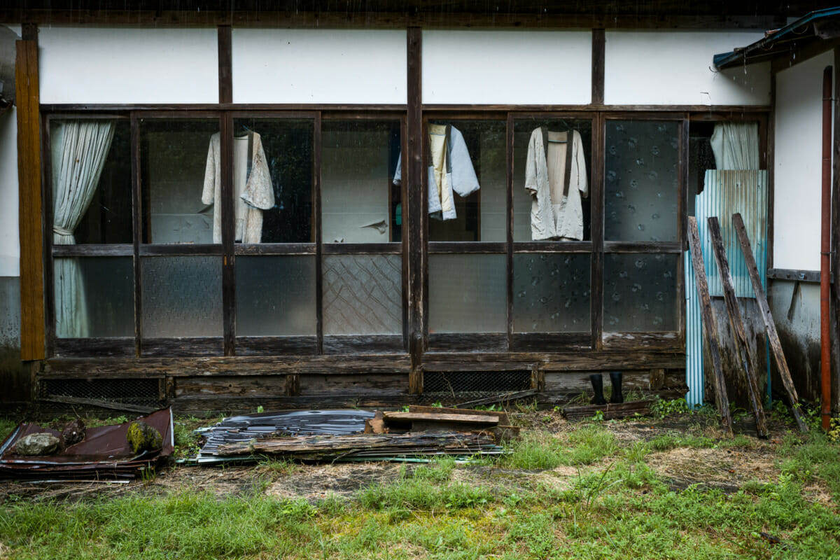 discarded clothes outside an abandoned Japanese home