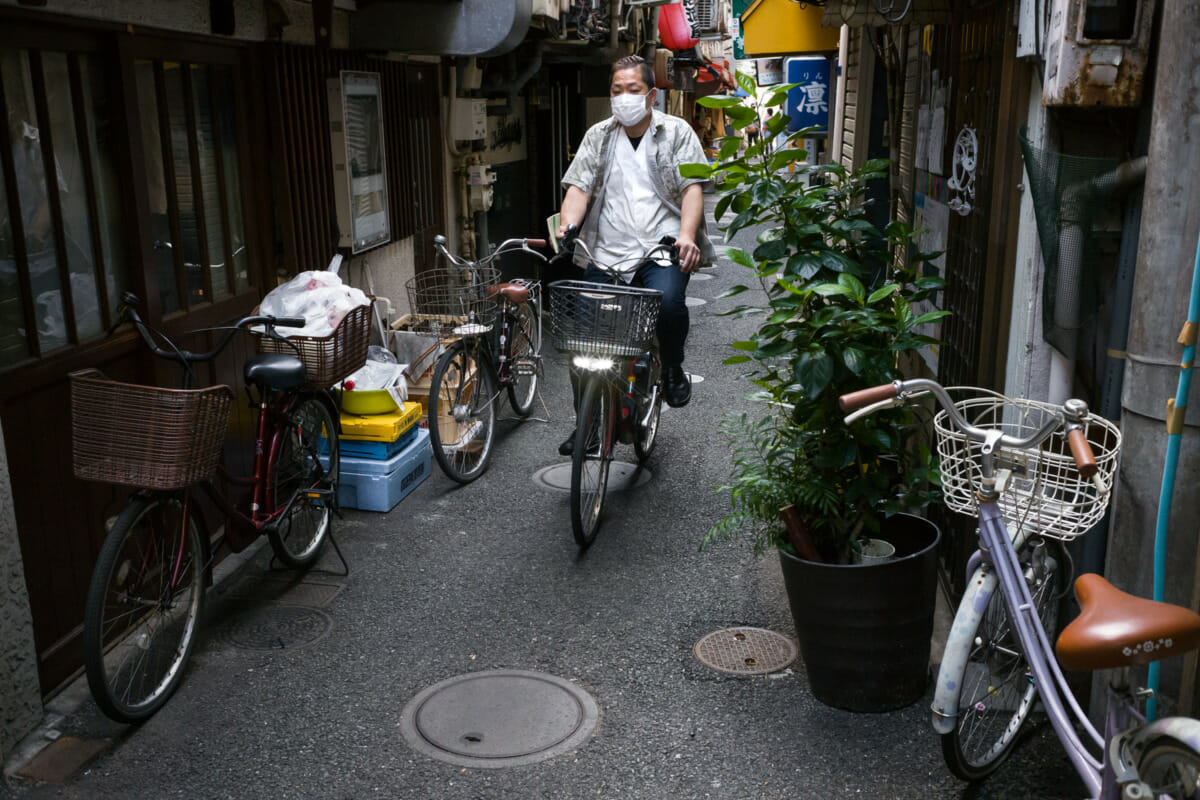 Tokyo alleyway bike rider