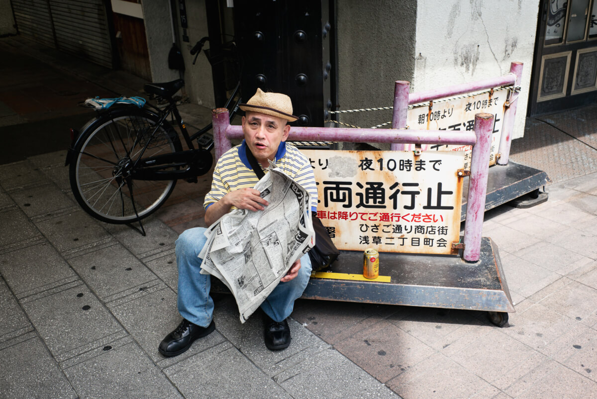 tokyo newspaper reader in the street