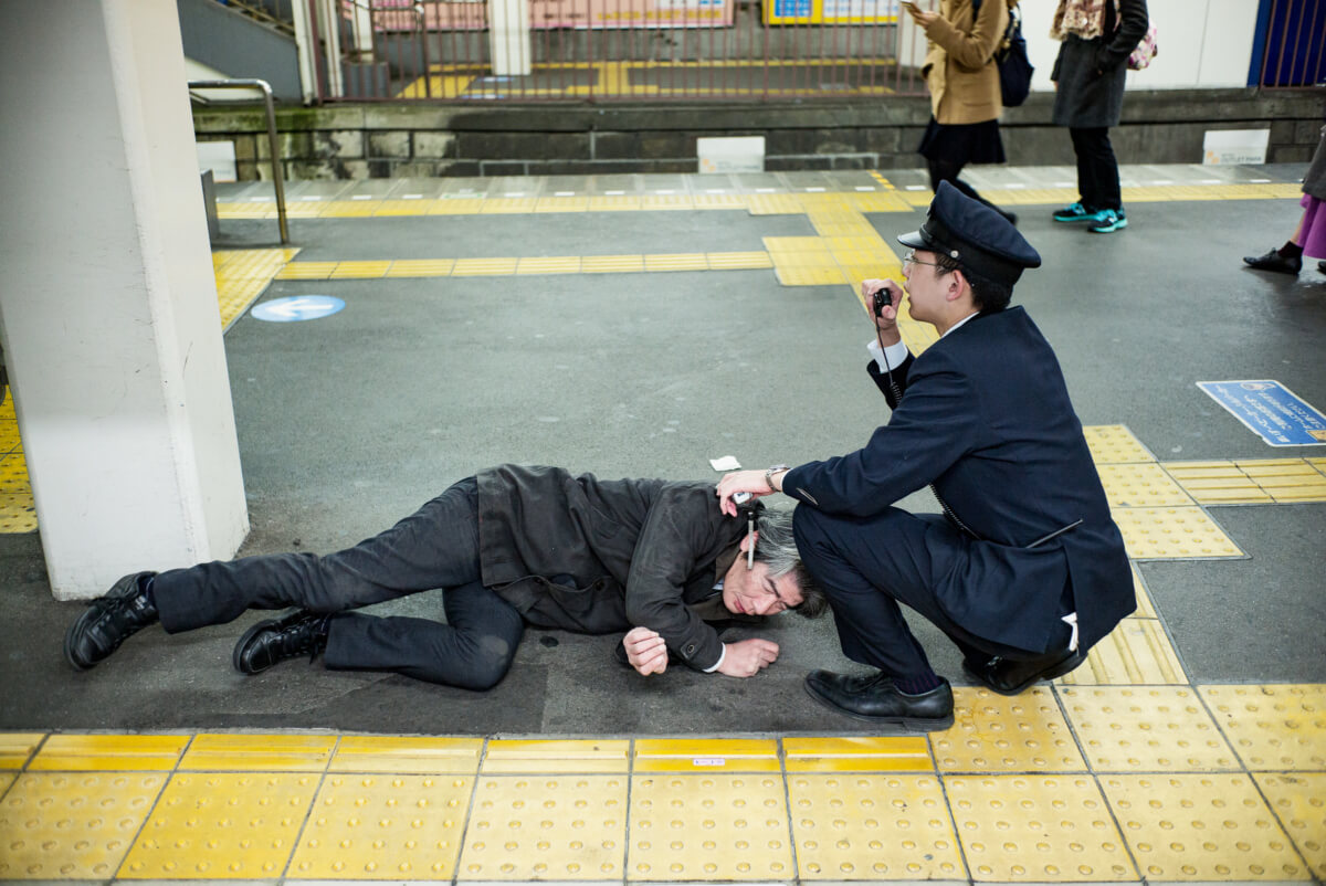 japanese man drunk at a tokyo train station